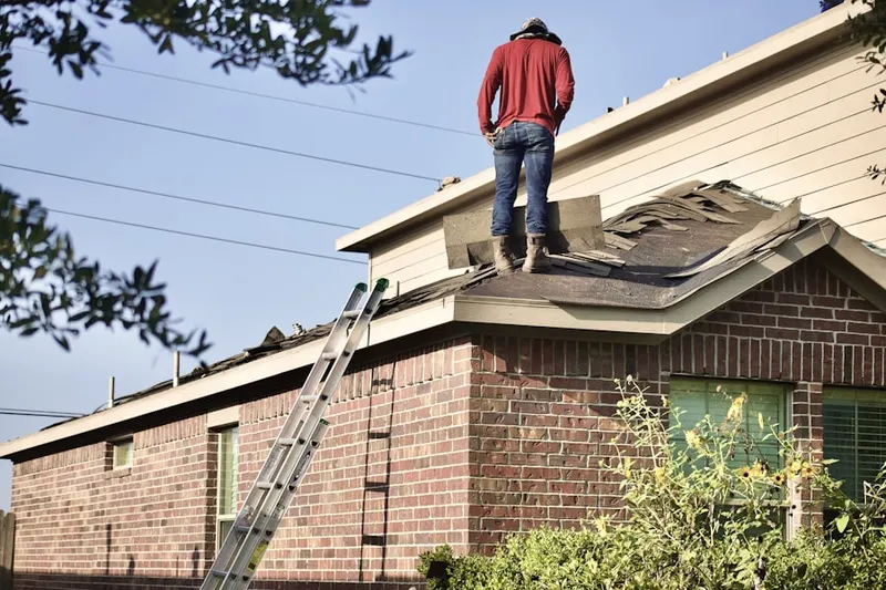 Professional roofer working on a residential roof in Del Aire